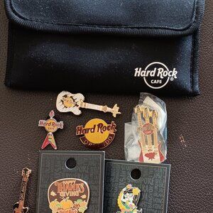 Seven Hard Rock Cafe Pins with Storage Pouch Used